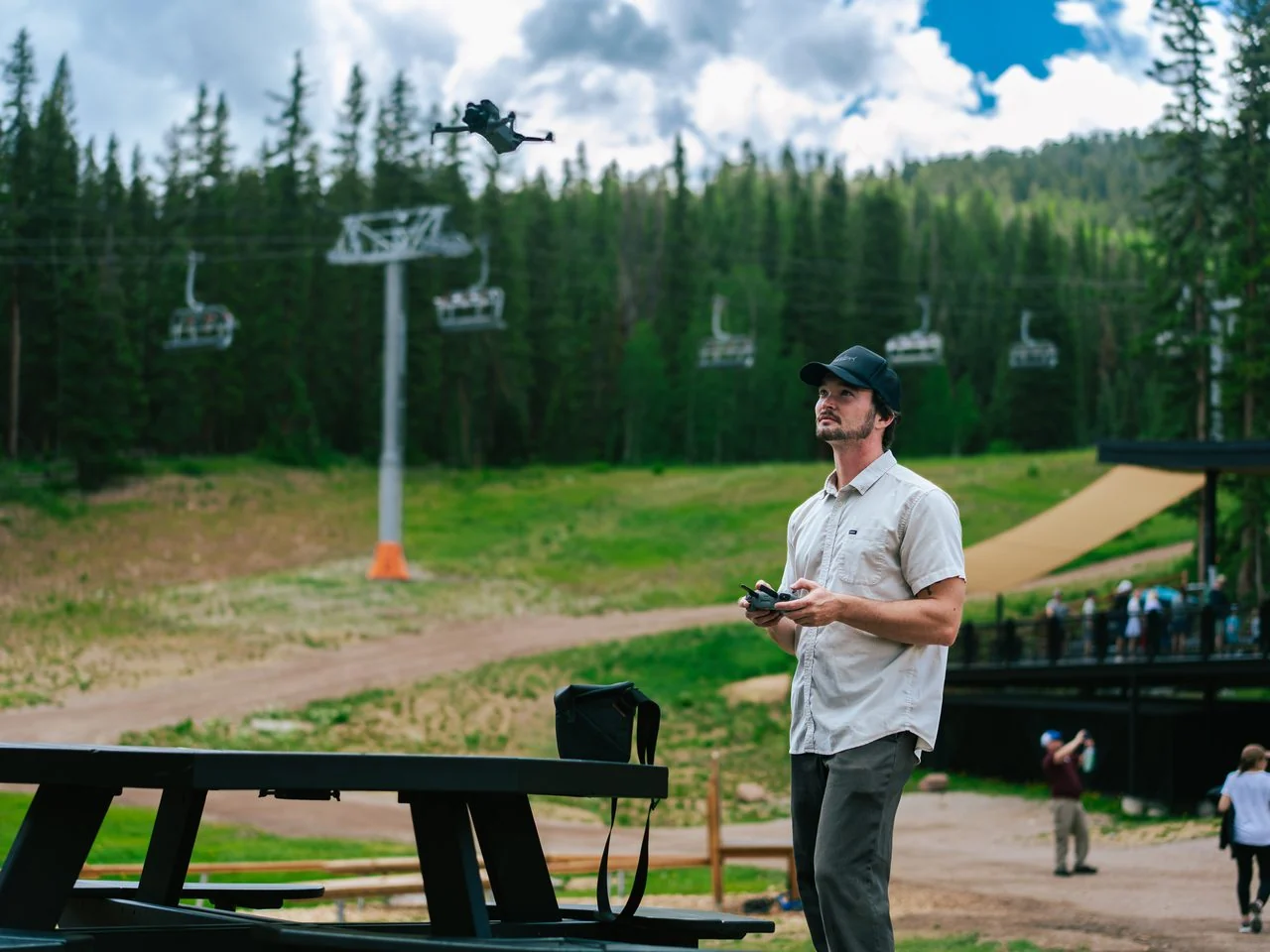 An EventShark crew member flying a drone beside a mountainside